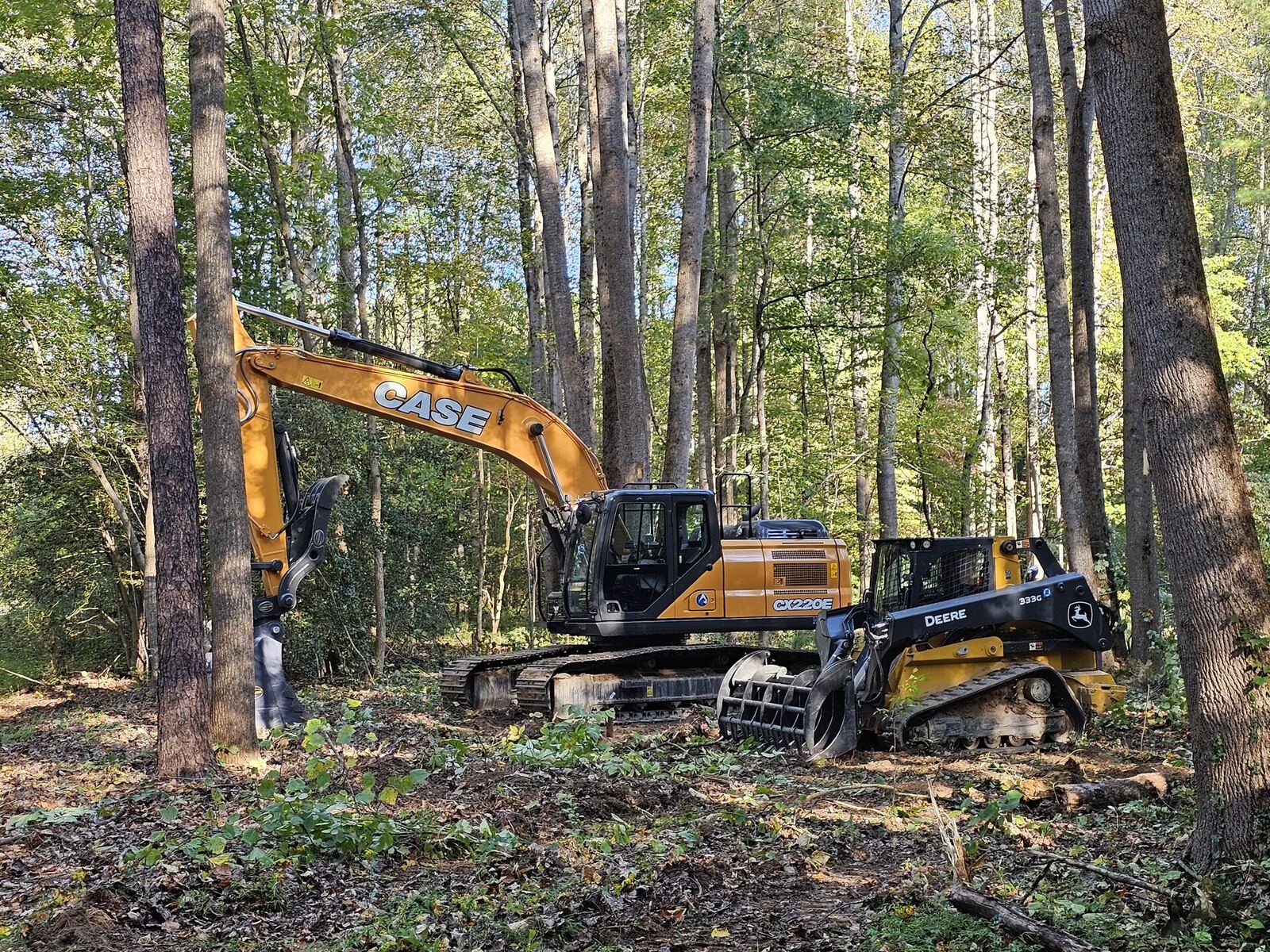 Case excavator and skid steer on a land clearing project in Virginia